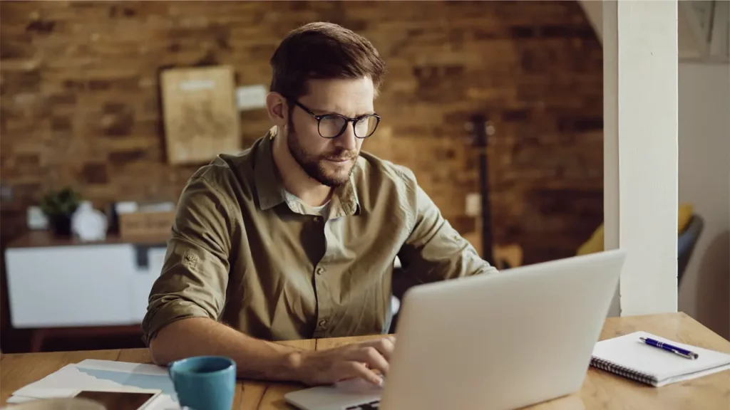 A man working on his laptop.