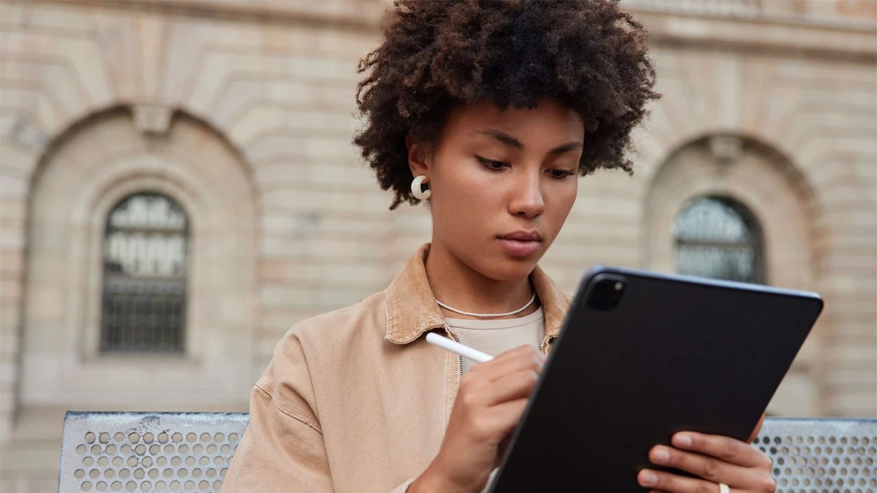 Publish an accessible transcript — A learner reads and annotates material on a tablet.