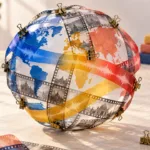 YouTube Auto Dubbing: Setup, Review, and When to Use a Manual Track — A globe assembled from film strips and colored audio ribbons, held together with brass clips, represents careful video localization.